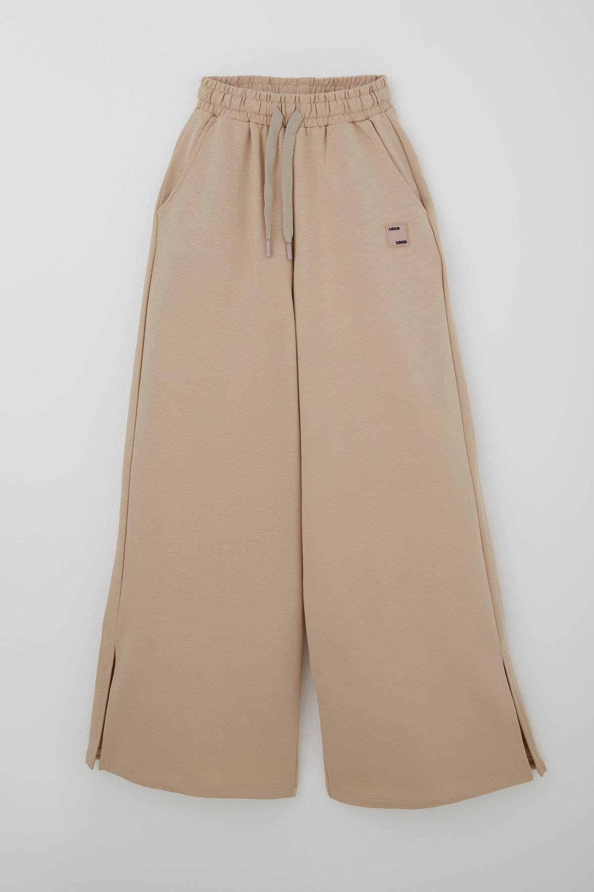 Locoloco Kız Çocuk Eşofman Altı Geniş Paça Yırtmaçlı Bağcıklı Arma Detaylı Bej (9-14 Yaş)