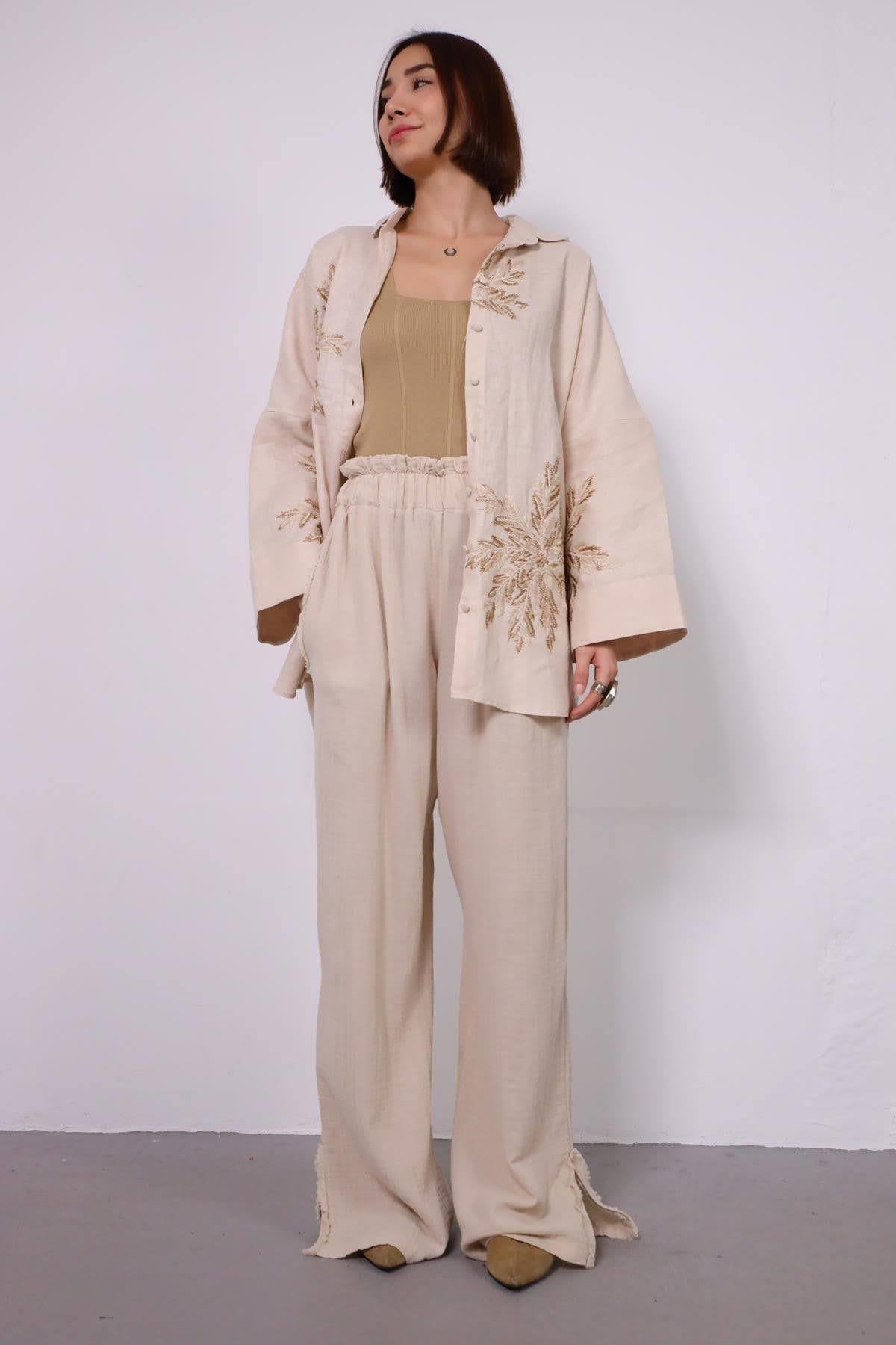 Krem Rengi Paçası Yırtmaç Detaylı Müslin Pantolon - Şaman Butik Krem Rengi Paçası Yırtmaç Detaylı Müslin Pantolon