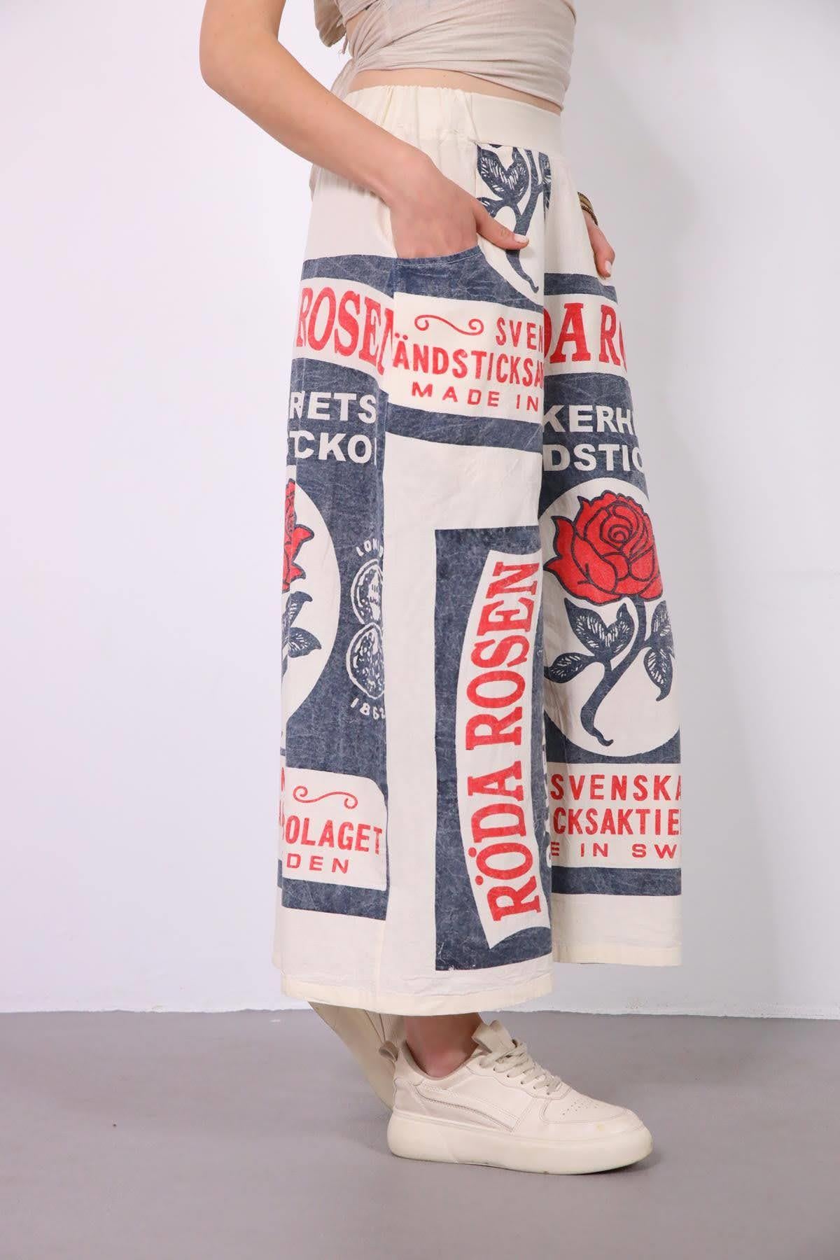 Ekru Yazı ve Çiçek Desenli Beli Lastikli Salaş Pantolon - Şaman Butik Ekru Yazı ve Çiçek Desenli Beli Lastikli Salaş Pantolon