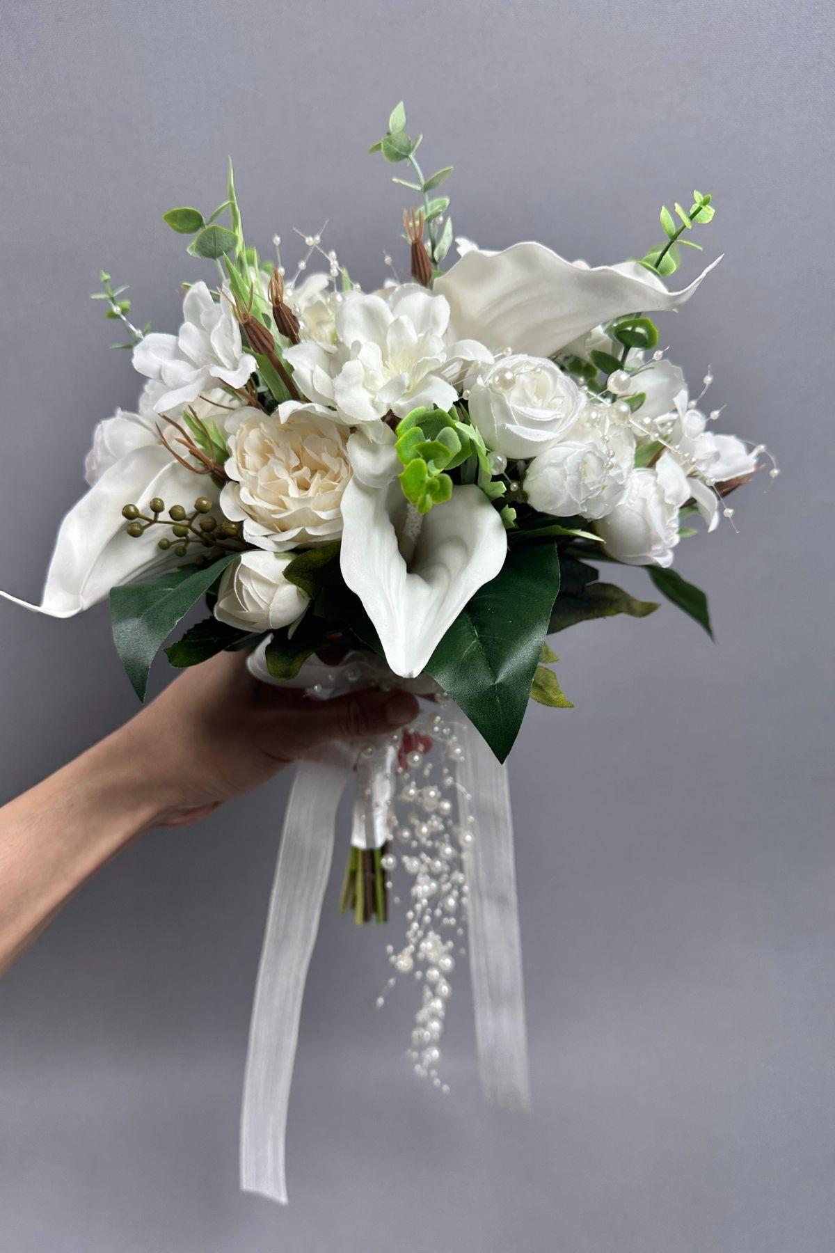 The set includes a bridal bouquet, wedding hat, feathered wedding pen, satin bridal gloves, and feathered earrings. It is a high-quality set and a designer bridal bouquet.