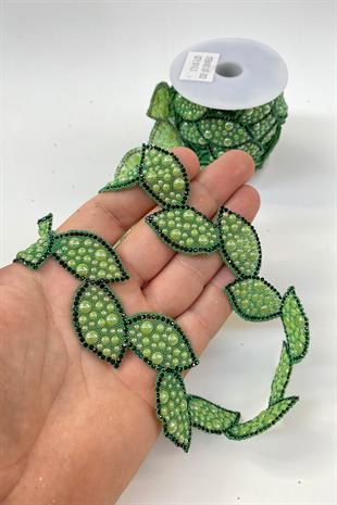 شمعدان من الحديد على شريط حجري مع شكل ورقة خضراء