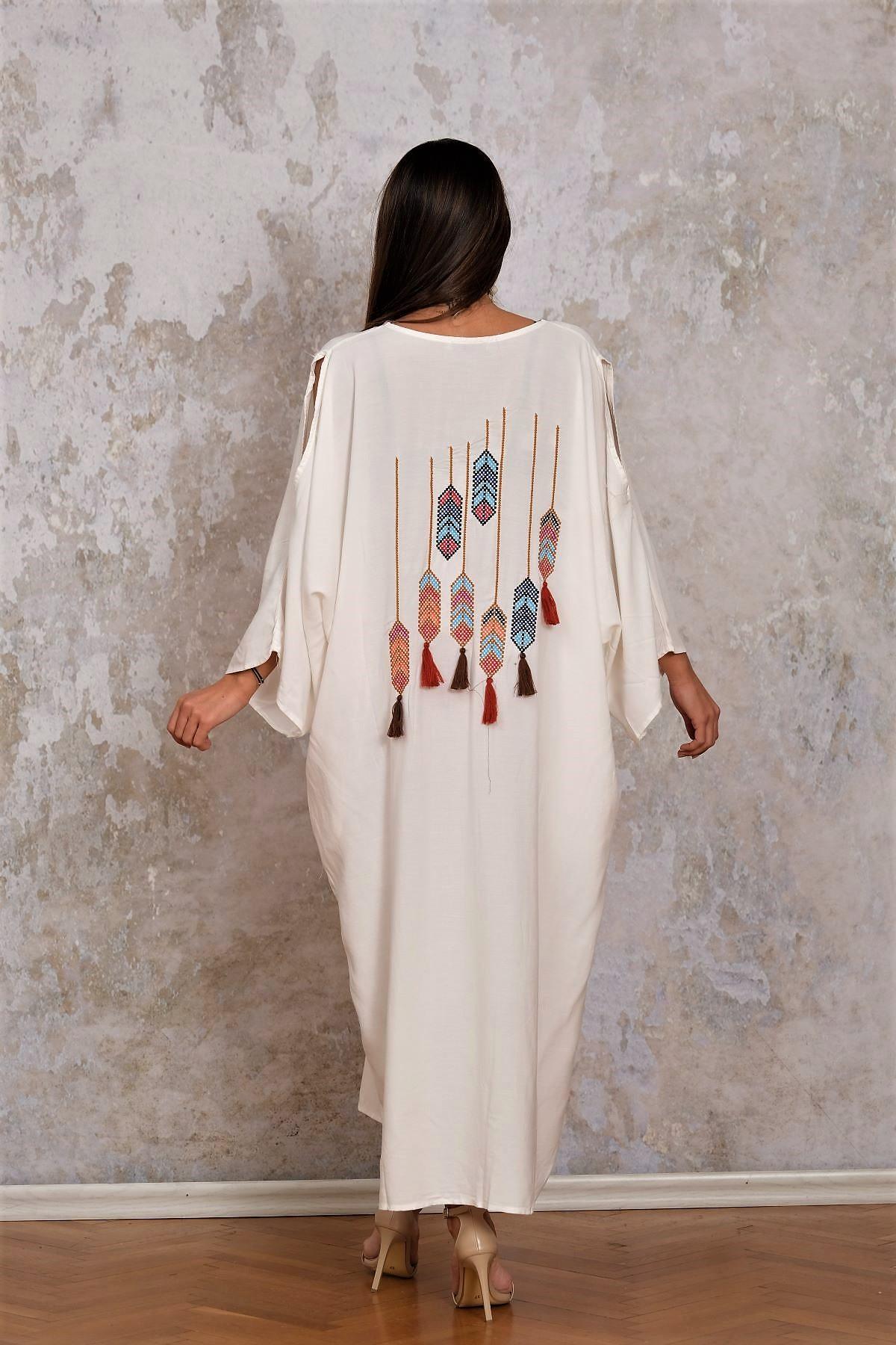 فستان طويل أبيض بياقة على شكل حرف V بجيوب مطرزة بأزرار من الخلف بياقة على شكل حرف V بجيوب مطرزة بأزرار