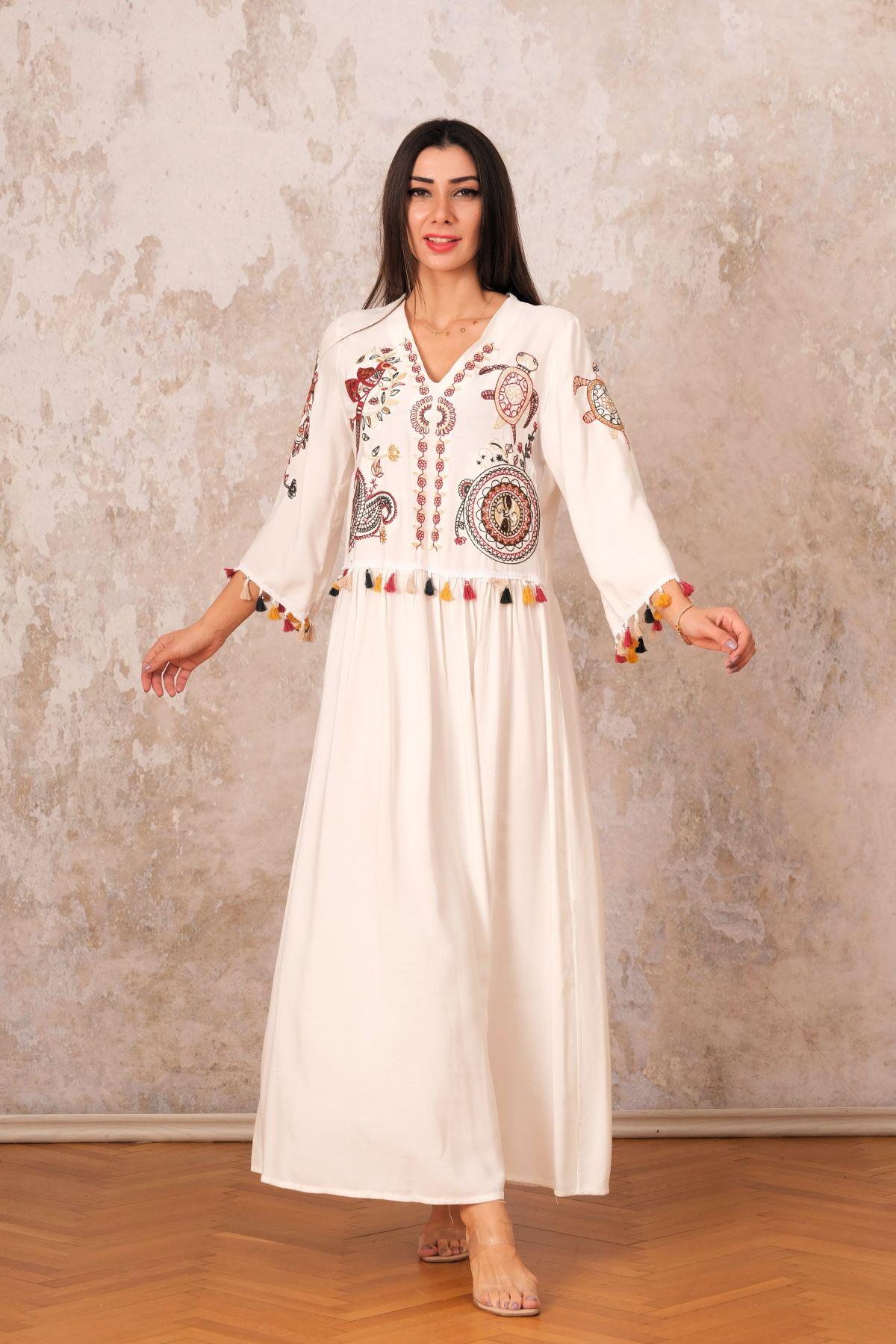 فستان طويل أبيض بياقة على شكل حرف V بياقة على شكل حرف V مع شرابات مطرزة أصيلة على الأمام والأكمام