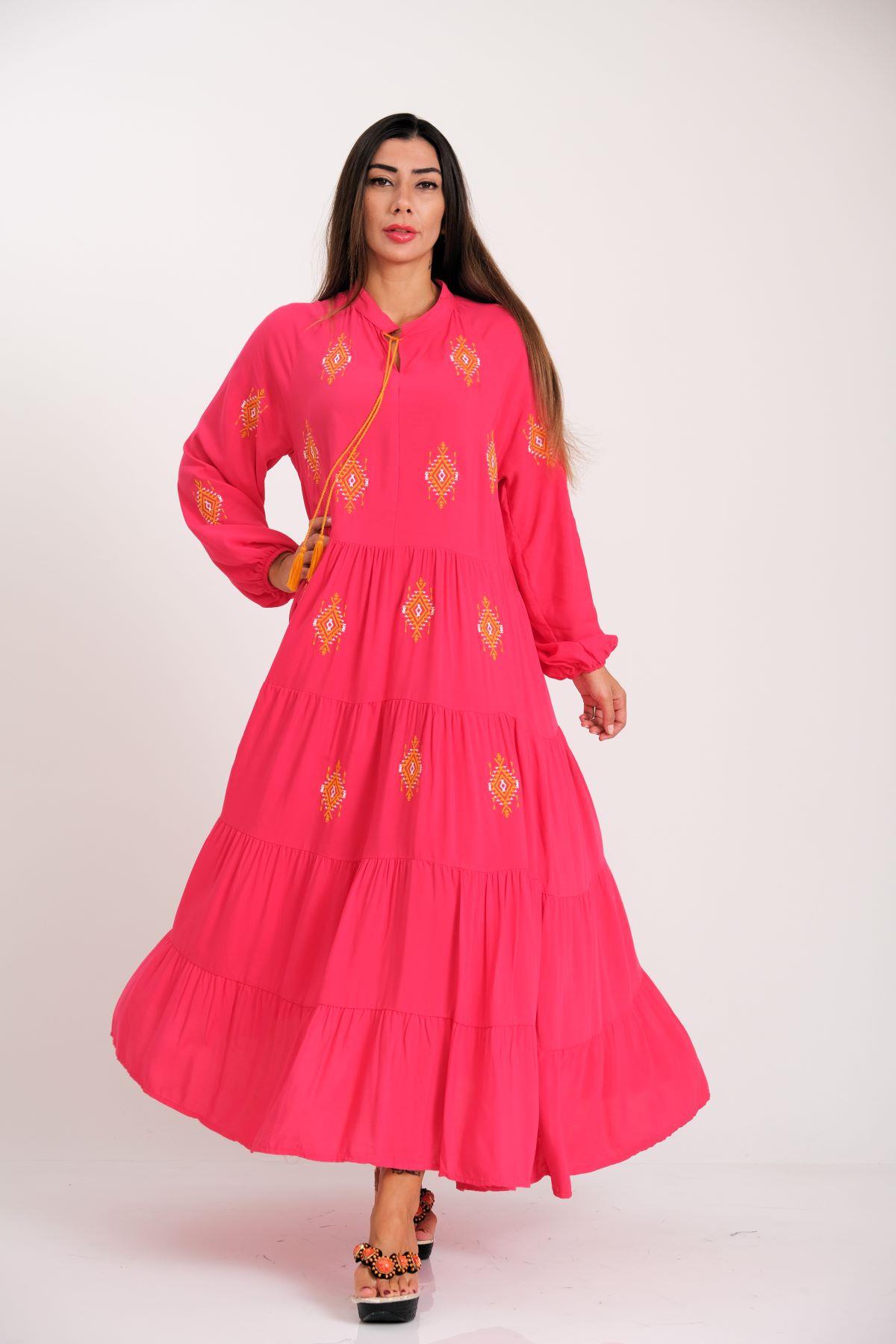 فستان طويل وردي اللون بتطريز أصلي من الأمام والأكمام وتنورة طويلة مطوية