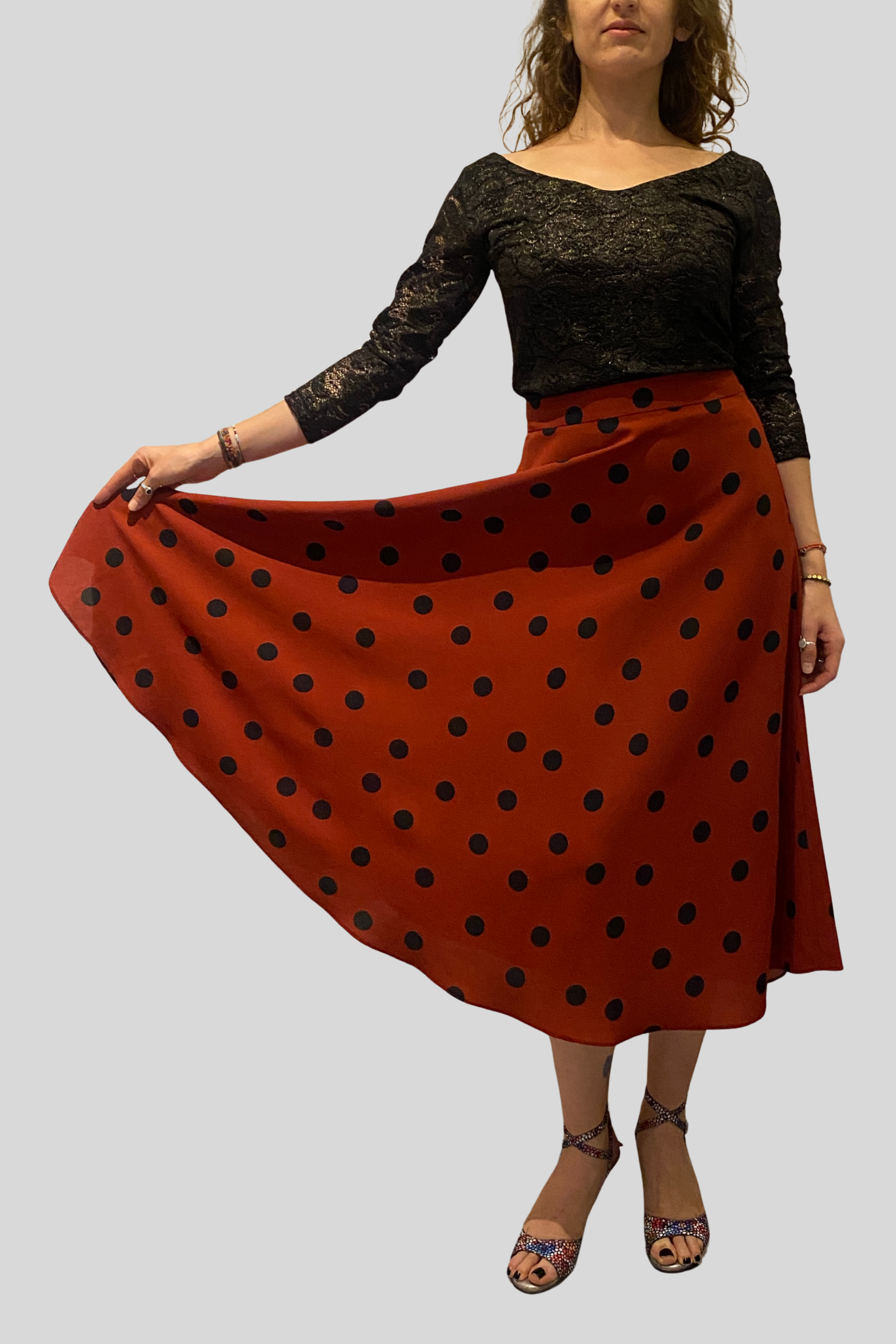 Circular terracotta color tango skirt with black polka dots, crafted from soft crepe fabric