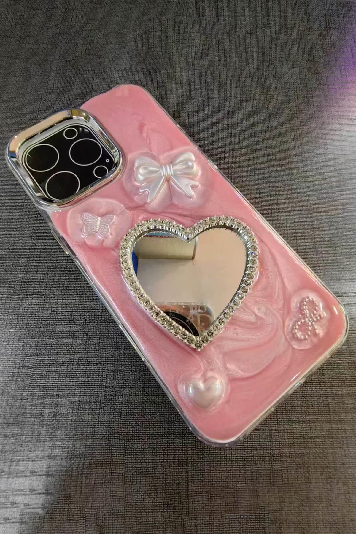 Pembe Renk Kalp Ve Kurdele Figürlü Ayna Detaylı 14 Pro Max Telefon Kılıfı