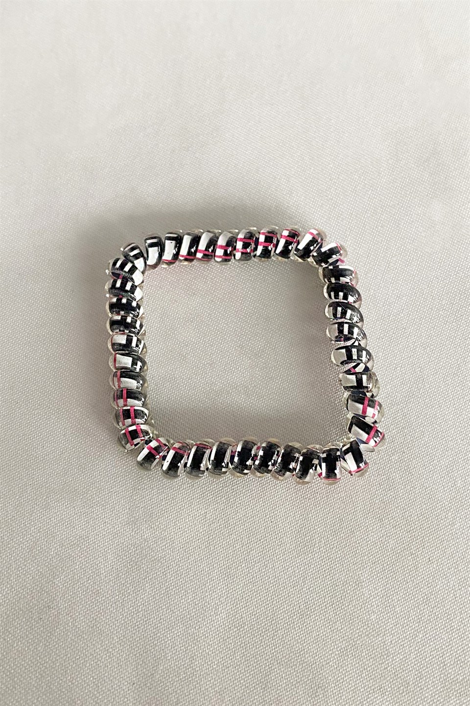 Black color pink striped spiral rubber buckle