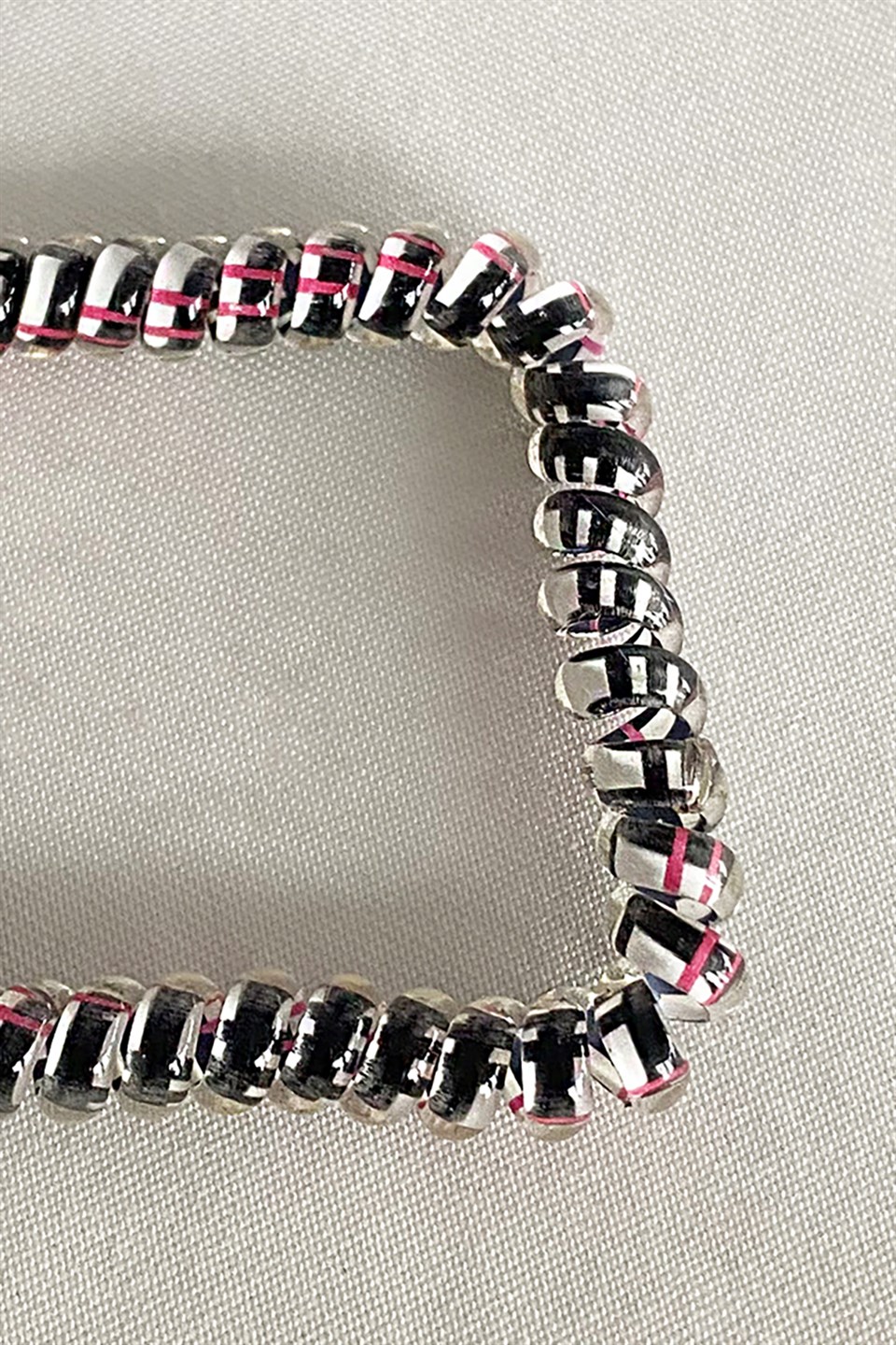 Black color pink striped spiral rubber buckle