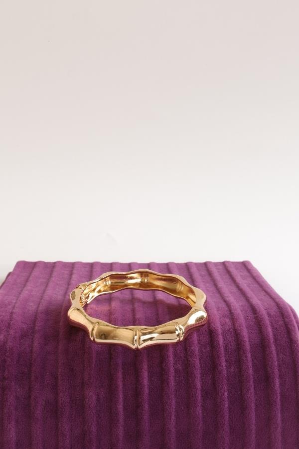 Gold-colored rectangular coated clamp.