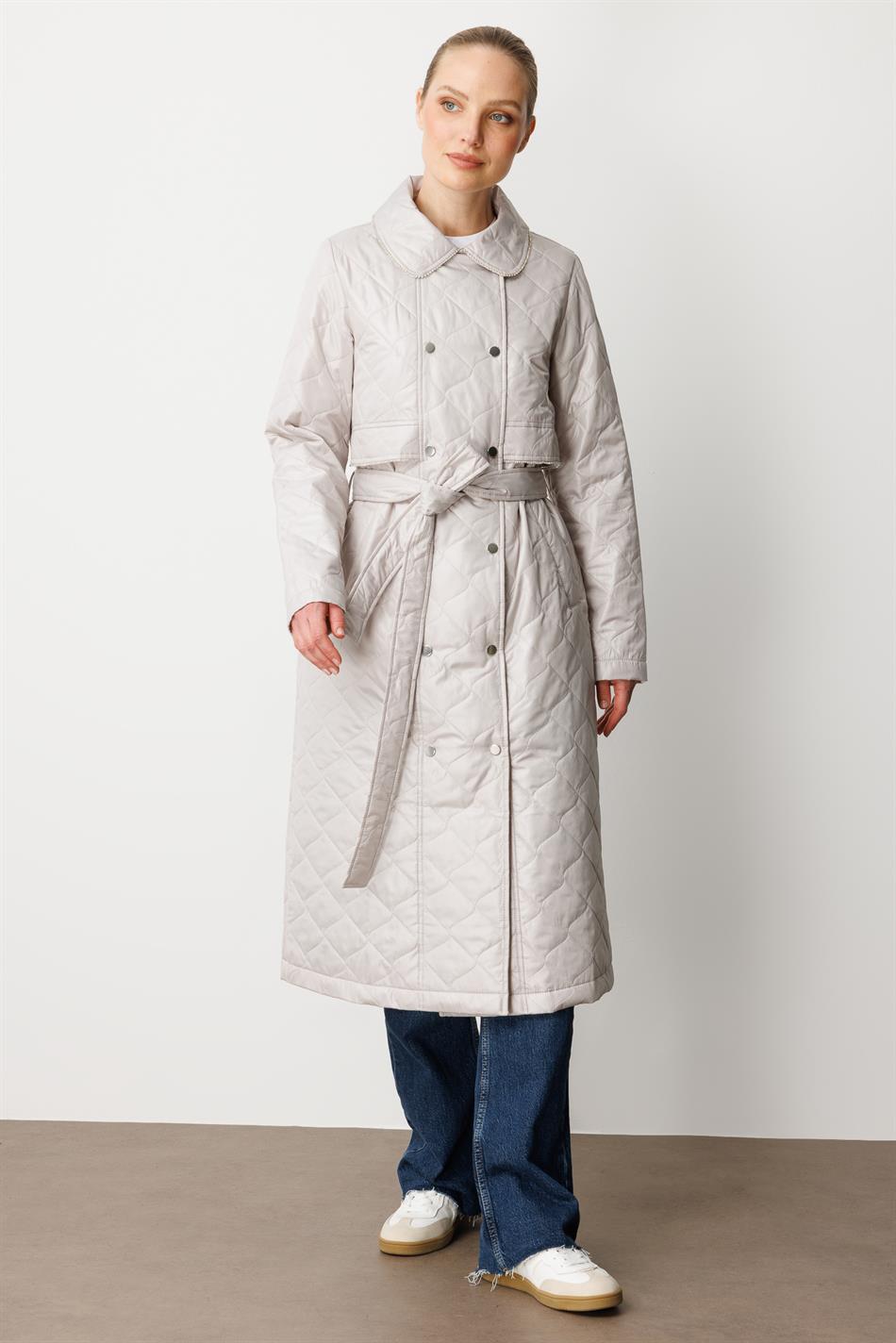 Soft, lightweight, quilted, padded, lined, and stone-trimmed seasonal trench coat/cape in grey.