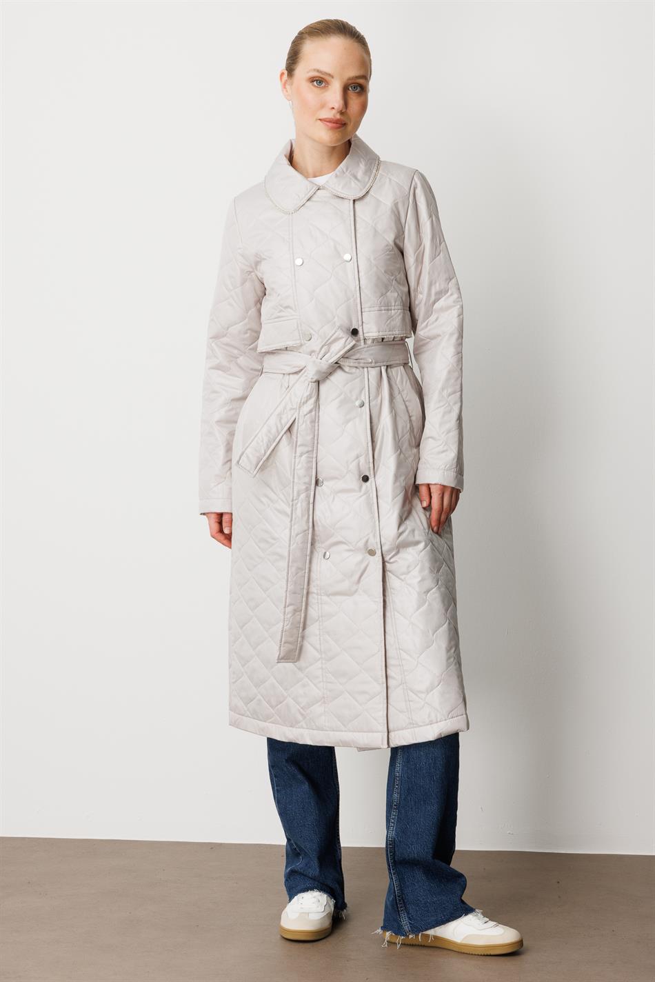 Soft, lightweight, quilted, padded, lined, and stone-trimmed seasonal trench coat/cape in grey.