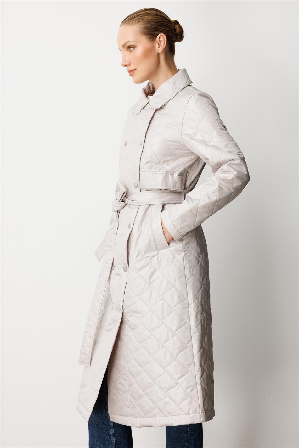Soft, lightweight, quilted, padded, lined, and stone-trimmed seasonal trench coat/cape in grey.