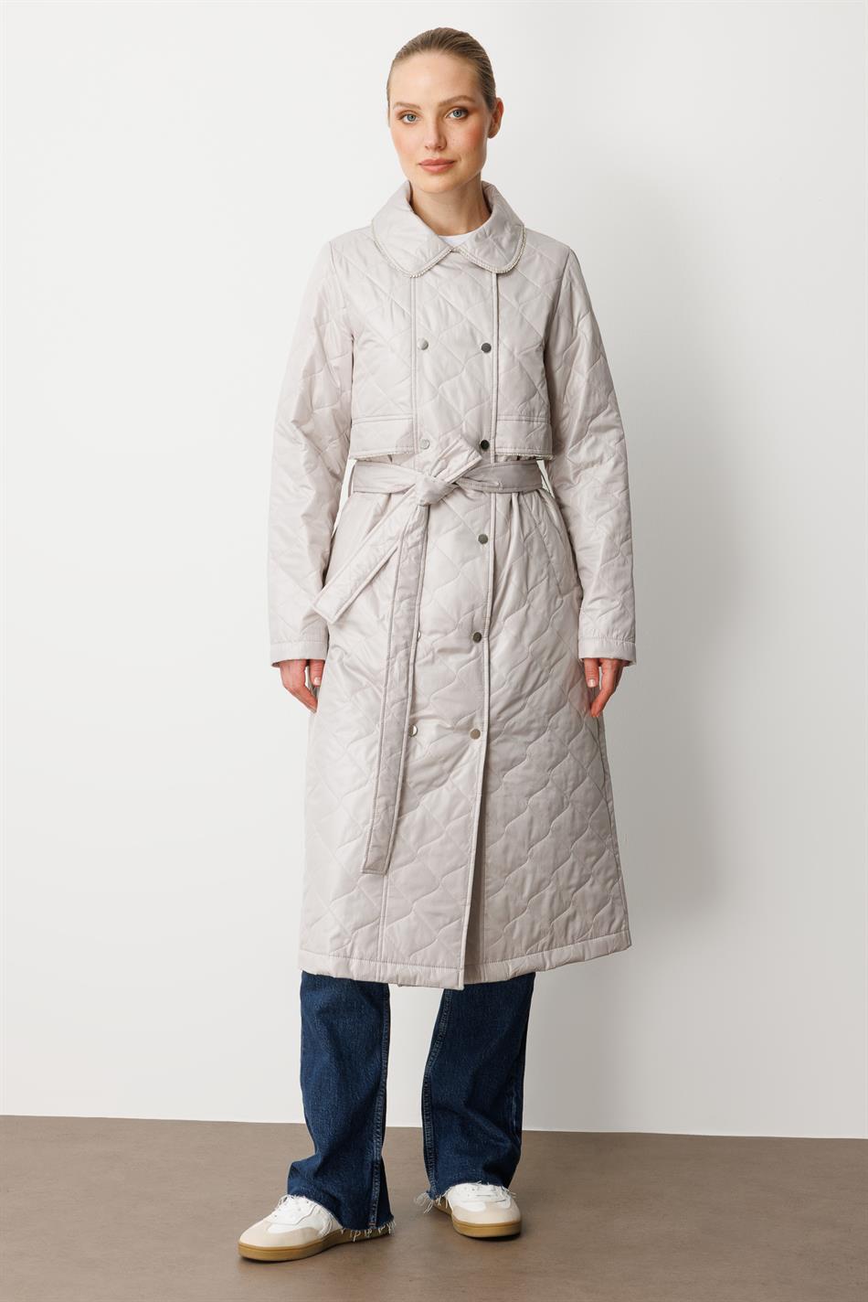 Soft, lightweight, quilted, padded, lined, and stone-trimmed seasonal trench coat/cape in grey.