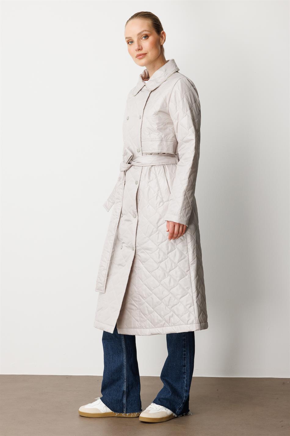 Soft, lightweight, quilted, padded, lined, and stone-trimmed seasonal trench coat/cape in grey.