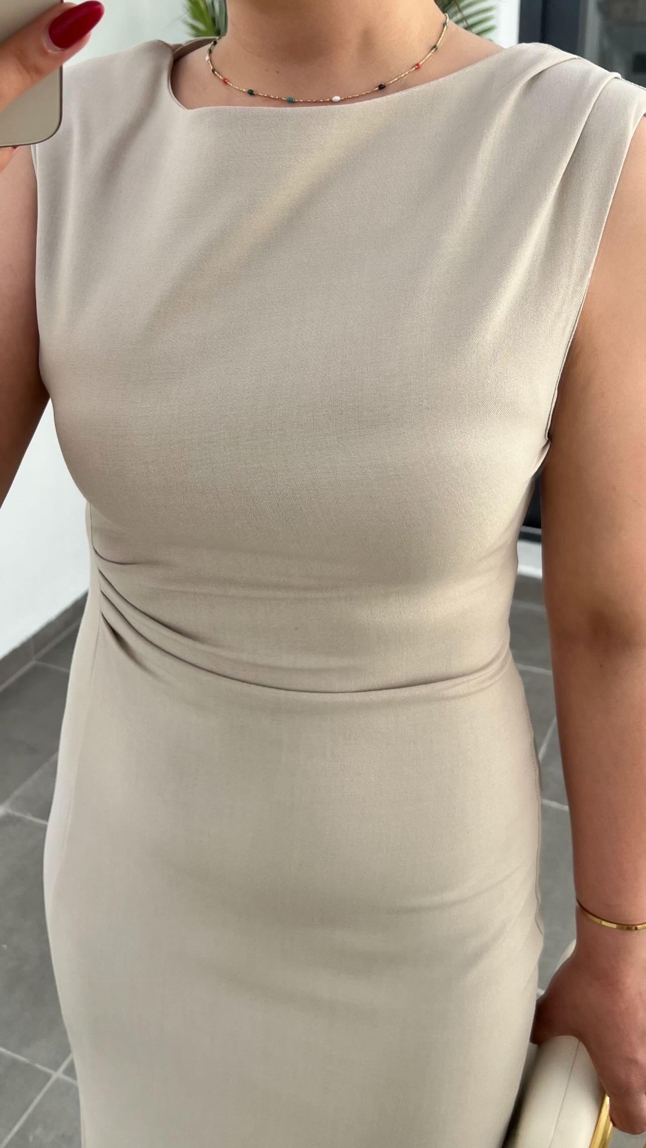 Beige Dress with Waist Drape, Slit Detail, and Padded Shoulders