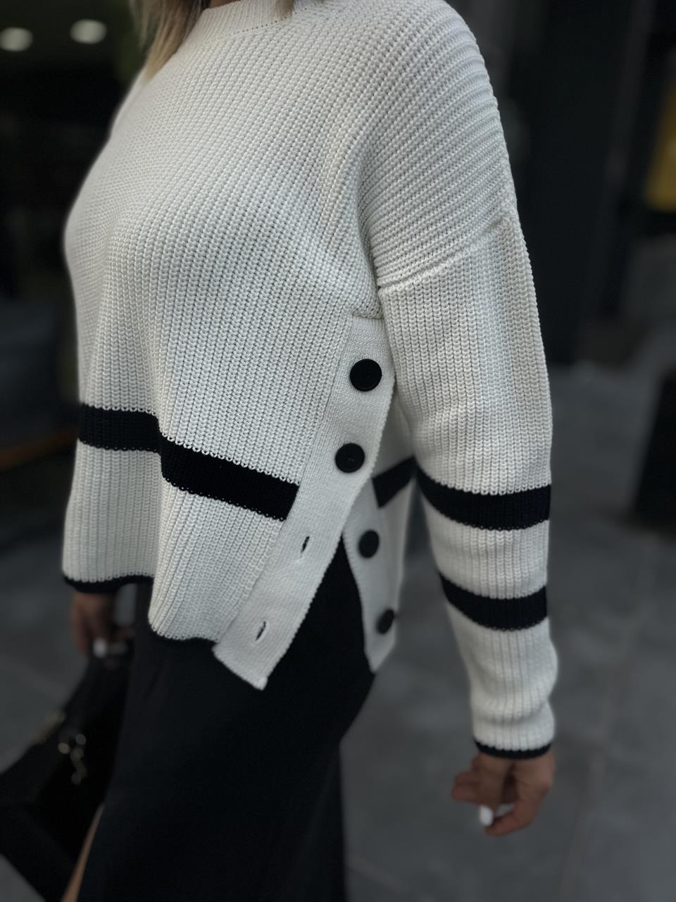 Off-white rib knit sweater with side buttons.