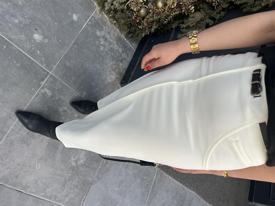 Off-white skirt with side zipper, stitching and slit detail, and belt.