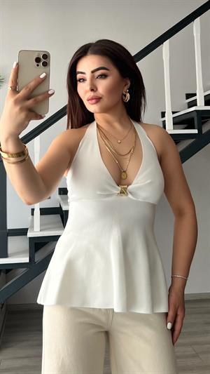 بلوزة بيضاء محبوكة بياقة هالتر مزينة بإبزيم ذهبي