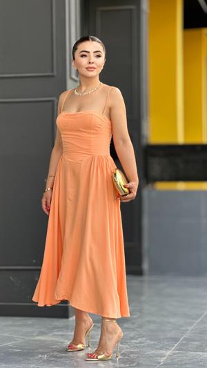Salmon-colored, strappy princess dress with bust cups.
