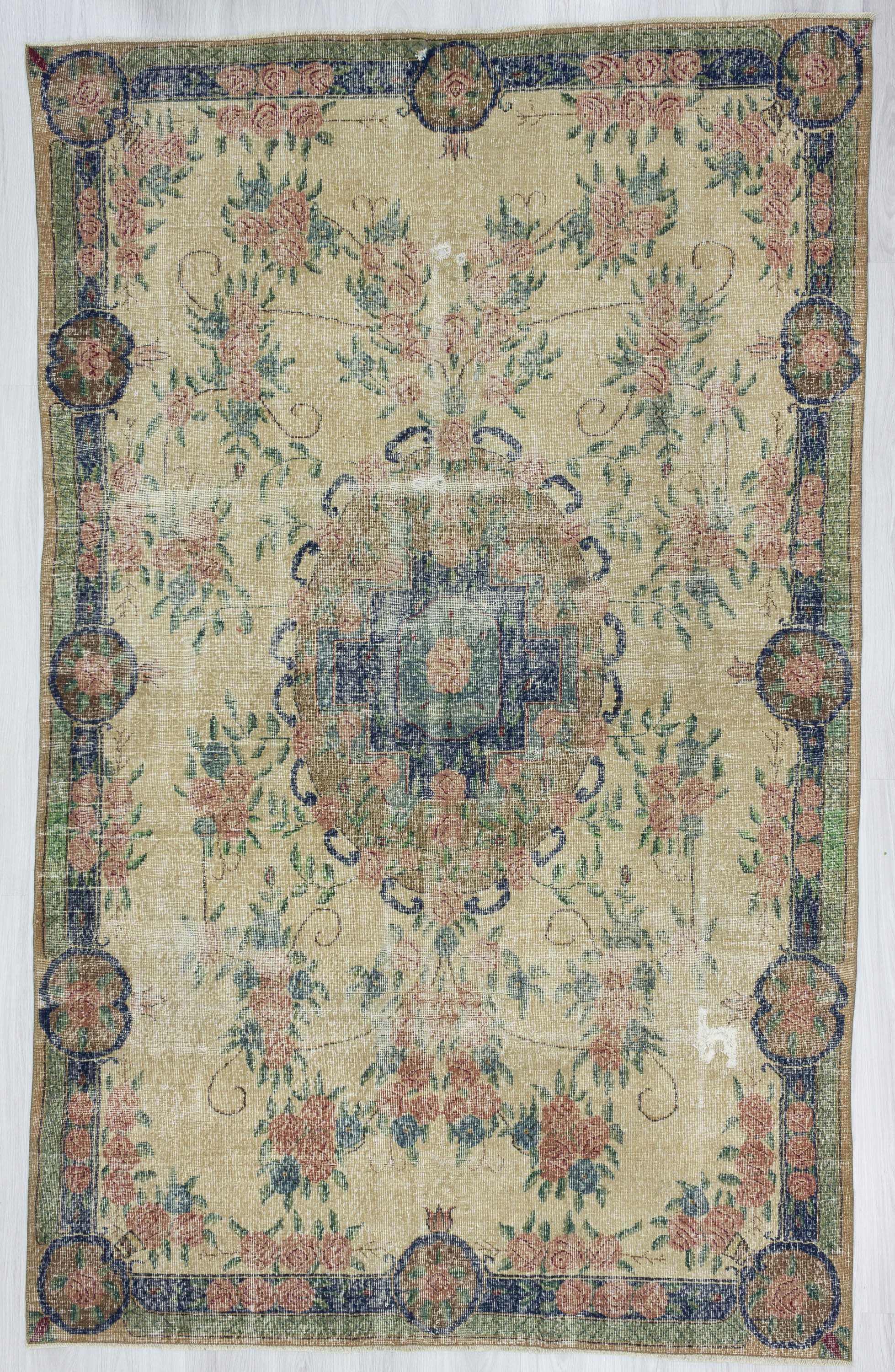 Distressed floral designed vintage Turkish rug