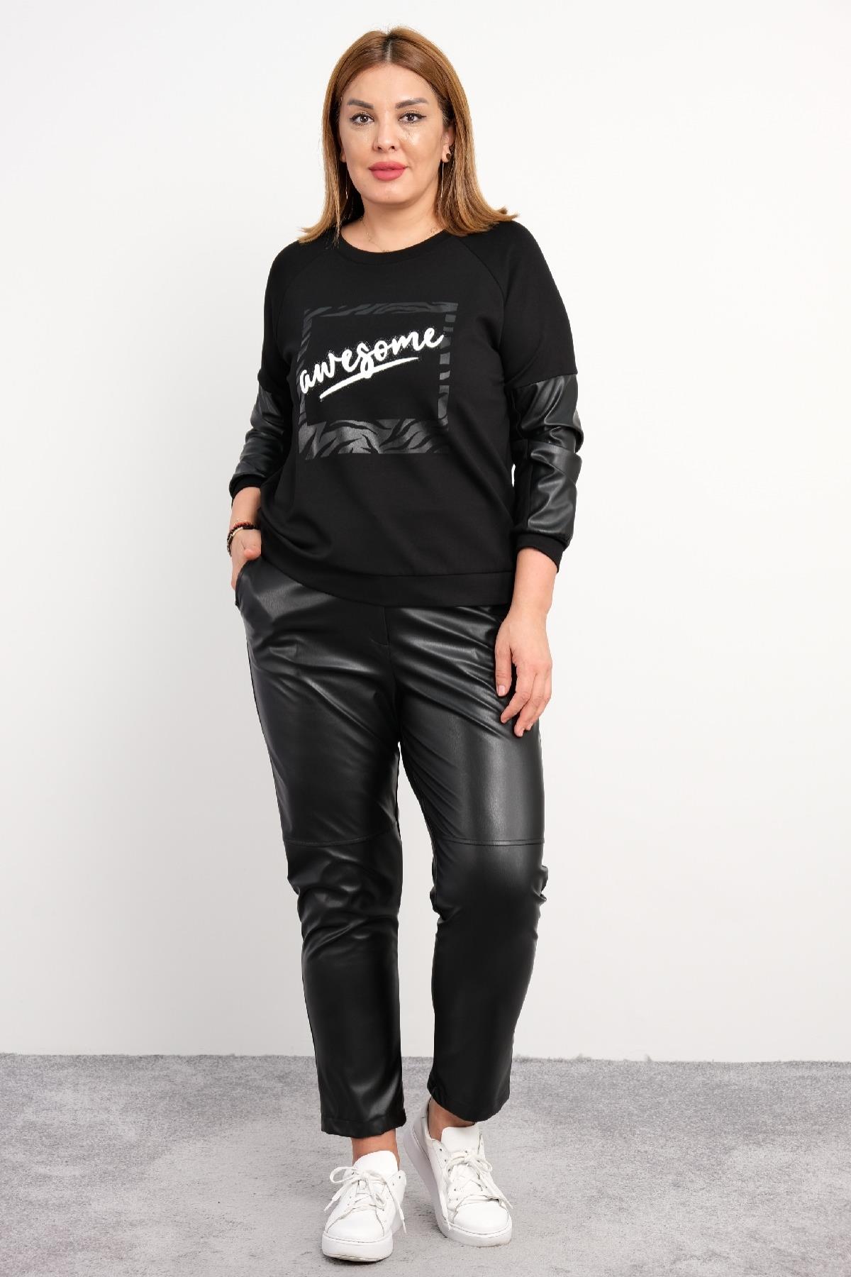 Bu büyük beden kadın ikili takım, modern ve şık tasarımıyla dikkat çekiyor. Takımın üst kısmı uzun kollu ve ön tarafında 