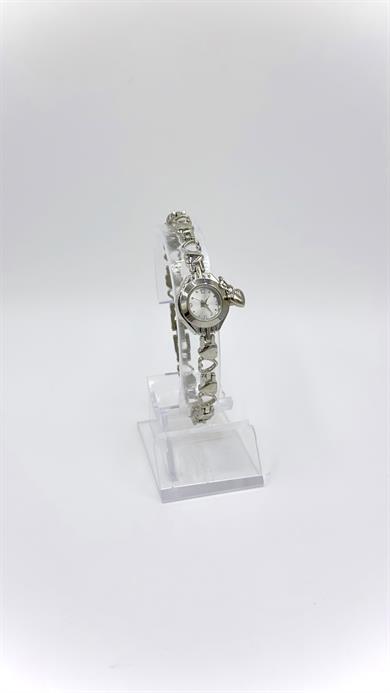 Kalpli  Sılver Kordonlu Yuvarlak Beyaz Kadranlı Charmlı Saat