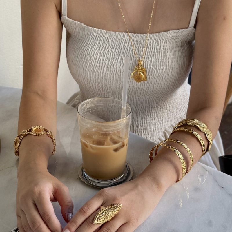 Stacked gold-plated bracelets