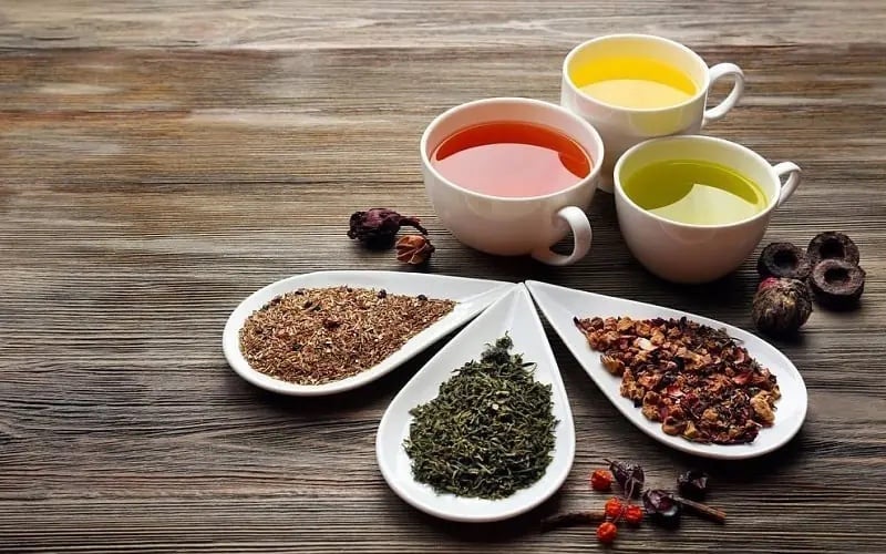 Kırmızı orman meyveleri çayı ve diğer çay türlerinin fincanlarda sunumu