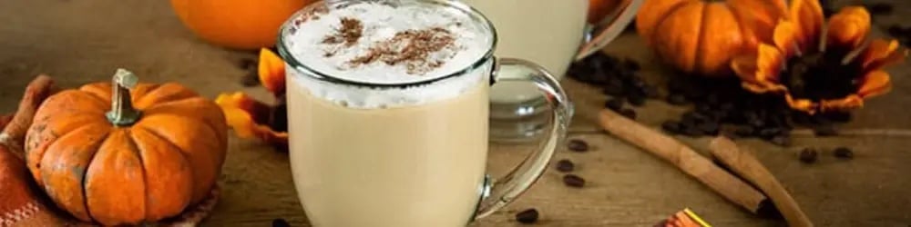 Evde pumpkin spice latte yapımı için balkabakları ve tarçın çubuklarıyla sunum