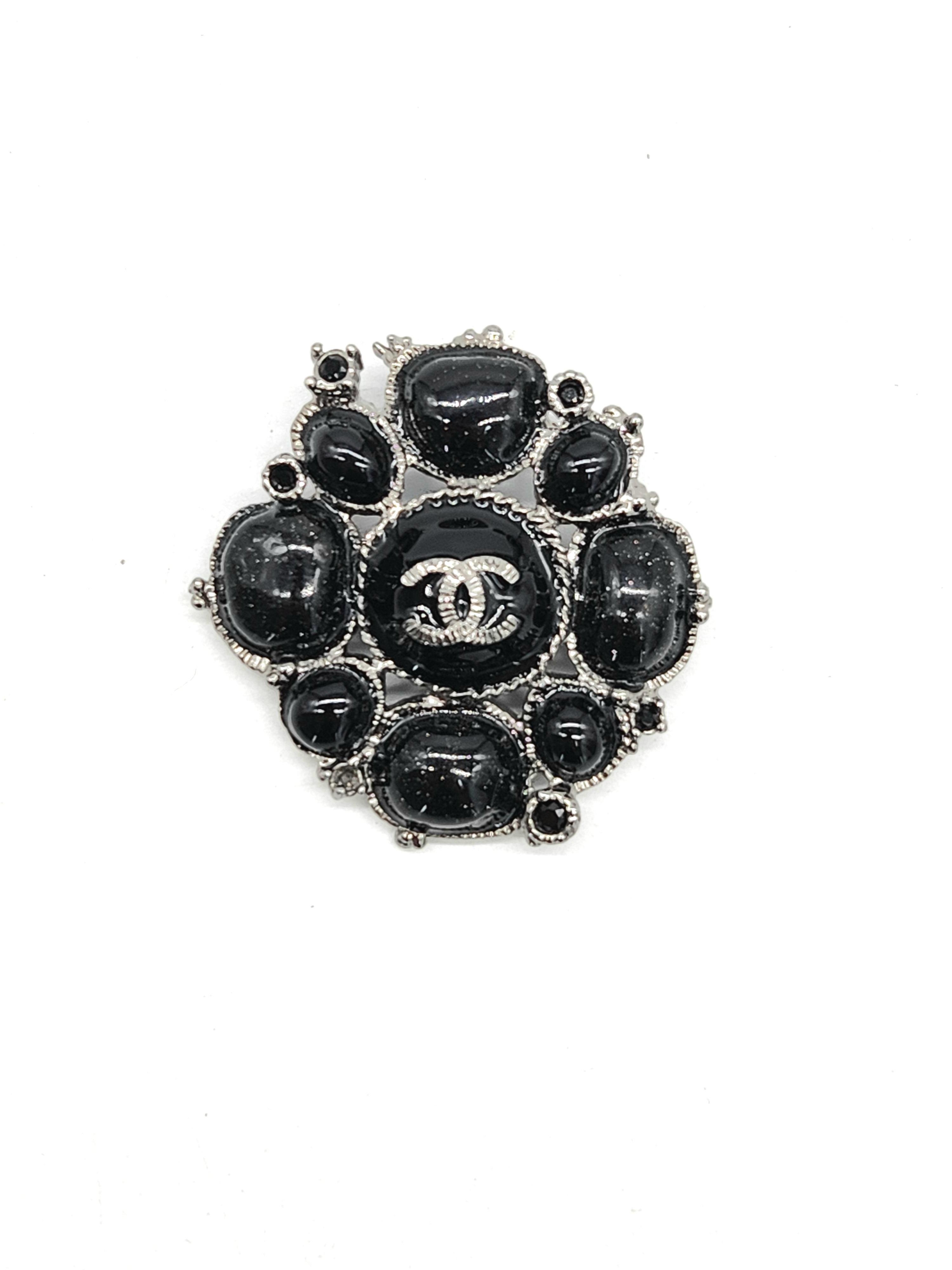 Black chanel brooch deals