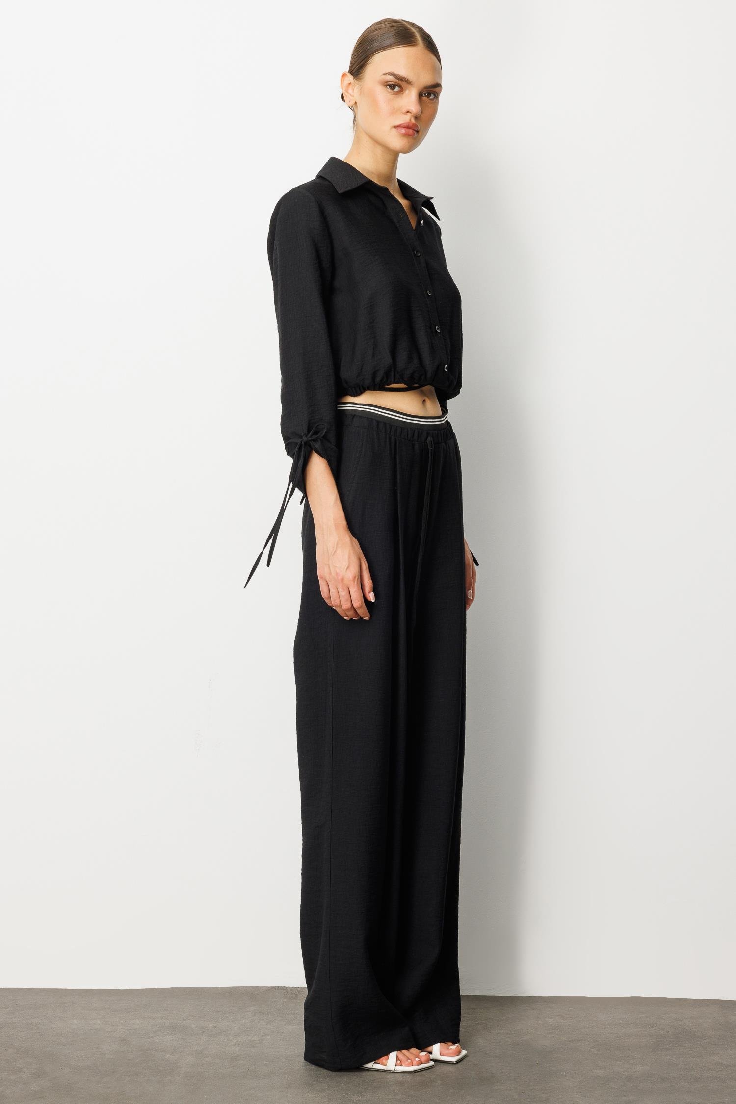 Modailgi  Beli Lastik ve Ribana Detaylı Bol Paça Pileli Yandan Cepli Yüksek Bel Pantolon - 10037 Siyah