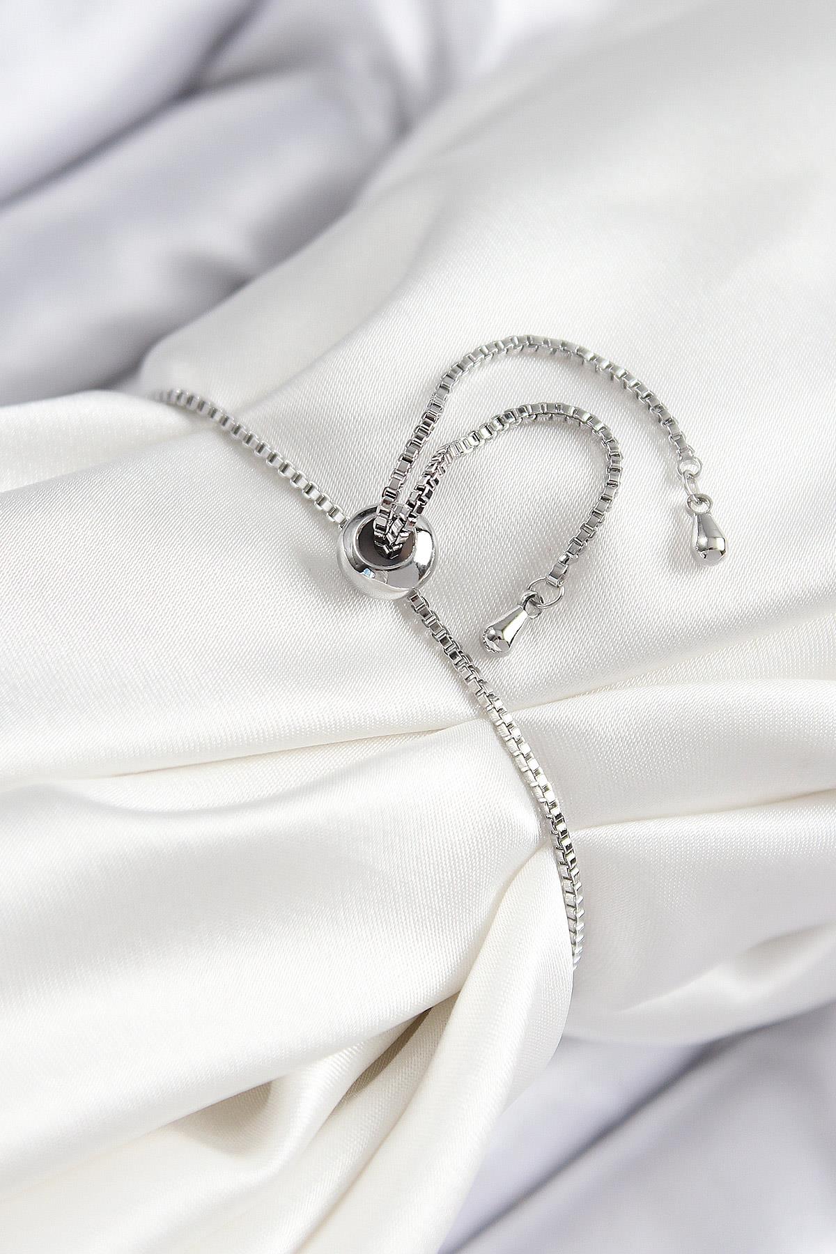 Pirinç Zirkon Taşlı X Detaylı Su Yolu Model Gümüş Renk Asansörlü Kadın Bileklik