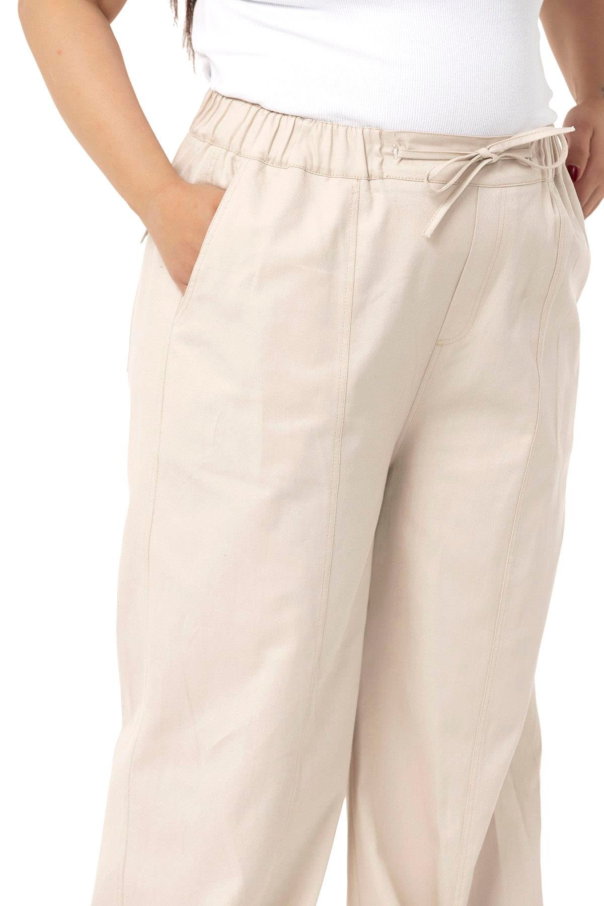 DISENTIS MODEST GENC BUYUK BEDEN GABARDIN PANTOLONDISENTIS MODESTBüyük Beden Geniş Paça Bağlama Detaylı Gabardin Bej Rengi Pantolon