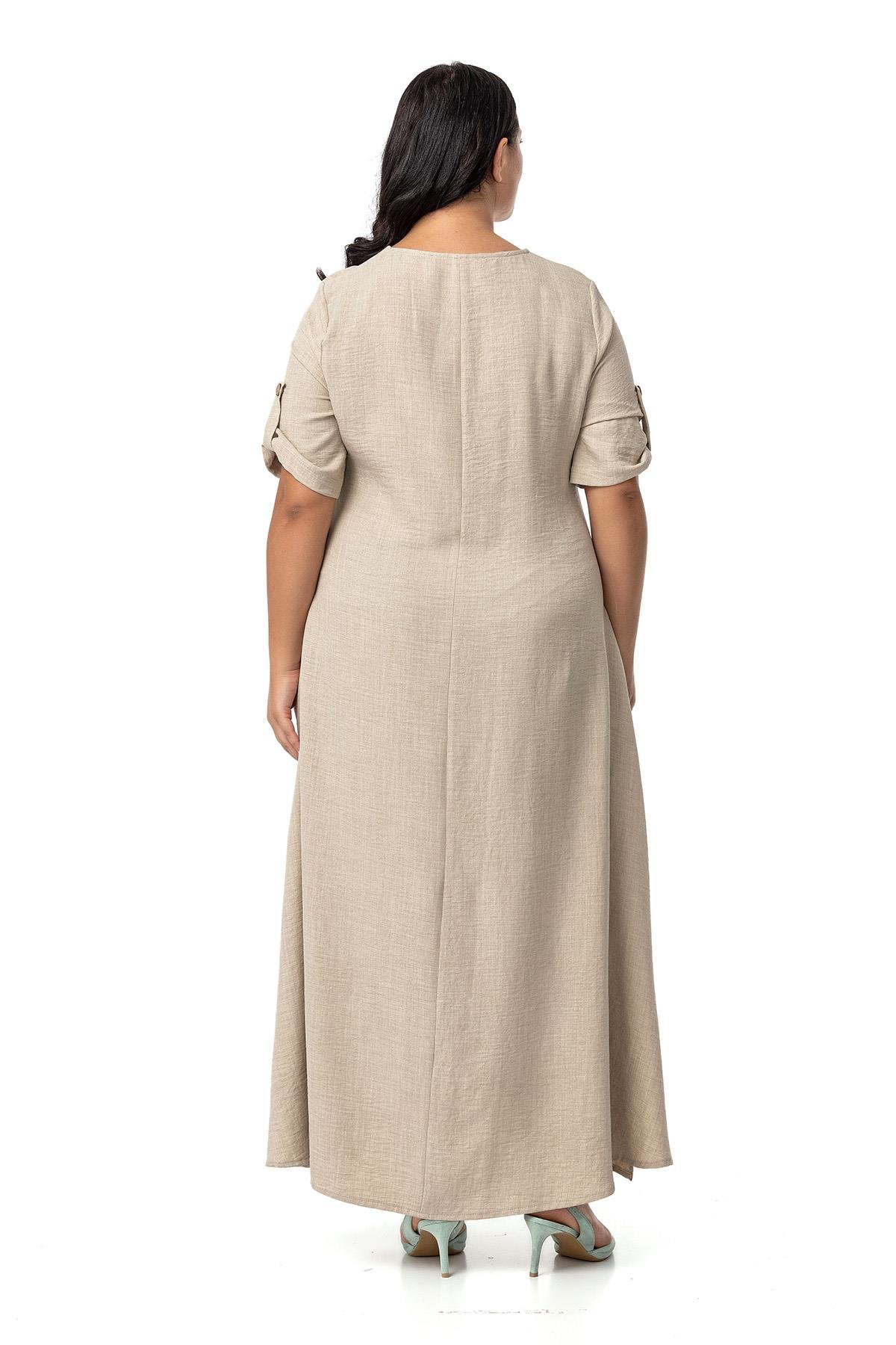 Disentis Modest Büyük Beden Katlamalı Yarım Kollu Apoletli Yırtmaçlı Uzun Bej Rengi Elbise DISENTIS MODESTBüyük Beden Katlamalı Yarım Kollu Apoletli Yırtmaçlı Uzun Bej Rengi Elbise 