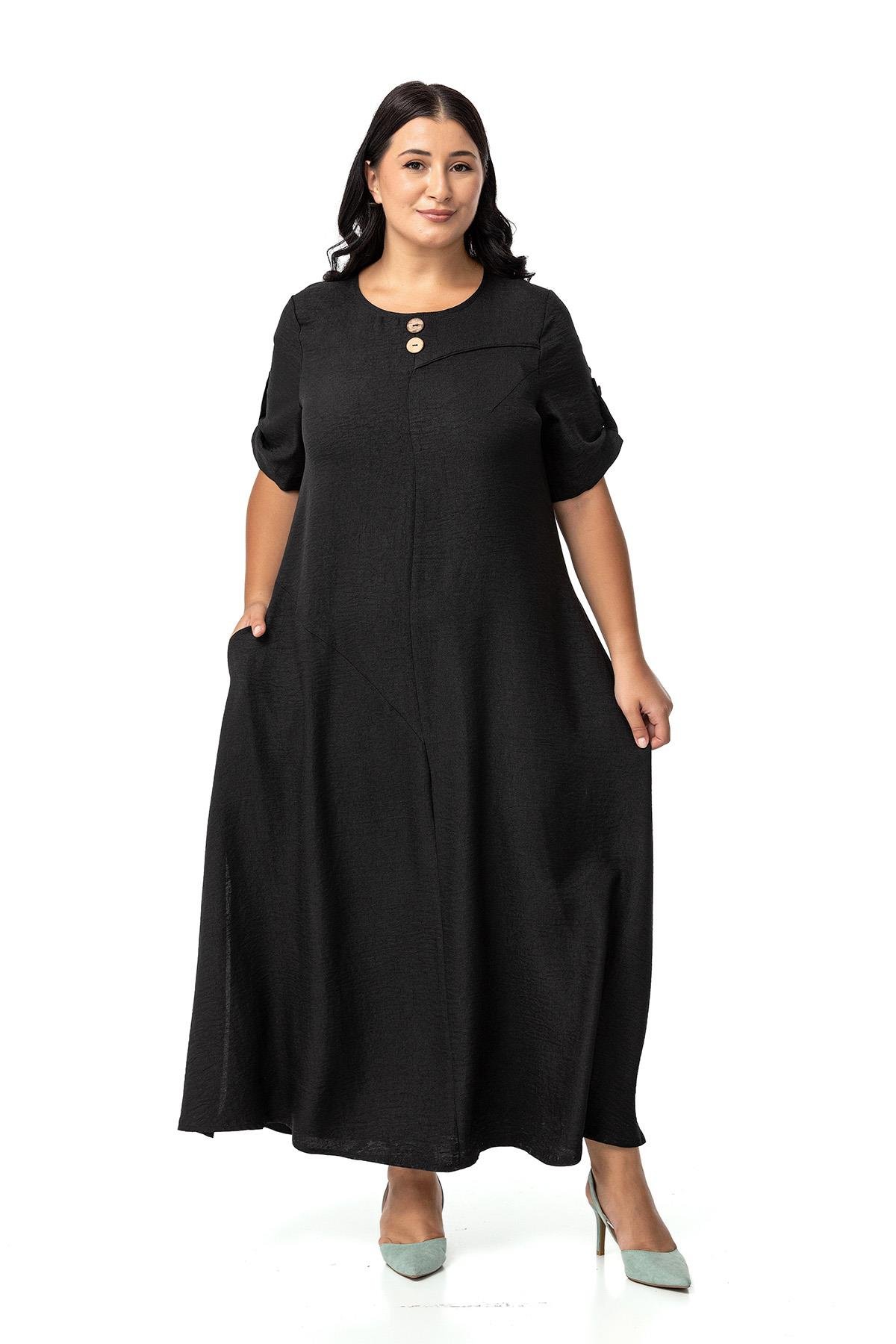 Disentis Modest Büyük Beden Katlamalı Yarım Kollu Apoletli Yırtmaçlı Uzun Siyah Elbise DISENTIS MODESTBüyük Beden Katlamalı Yarım Kollu Apoletli Yırtmaçlı Uzun Siyah Elbise 