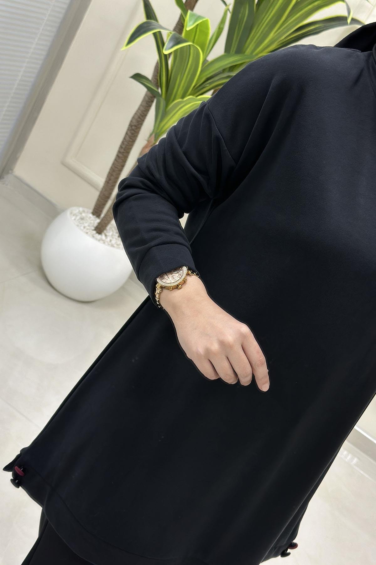 Tesettür Tunik ModelleriDüşük Omuz Etek Ucu Düğme Detaylı Modal Pike Kadın Tunik Siyah KADO 257498