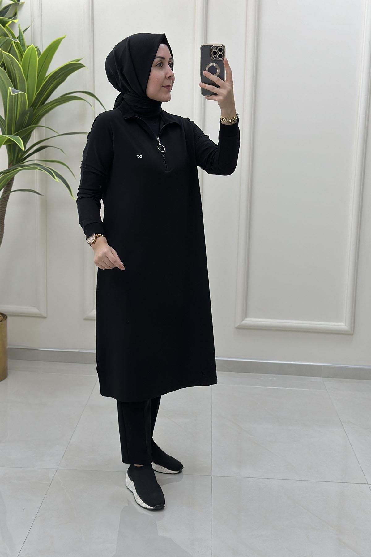 Tesettür Tunik ModelleriÖnü Yarım Fermuarlı Ribana Detaylı Kadın Tunik Siyah KADO 257322