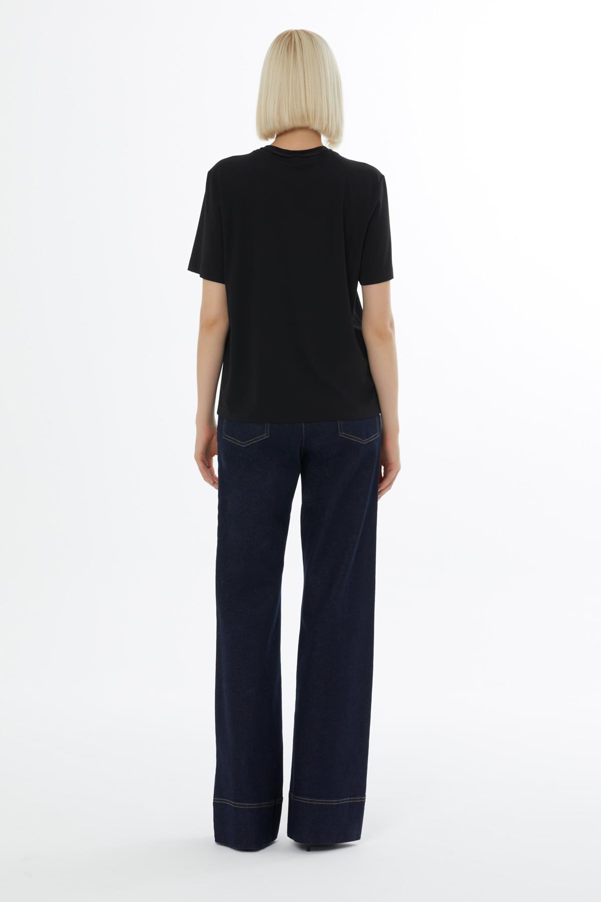 Black Blouse with Minimalist Accessory Details