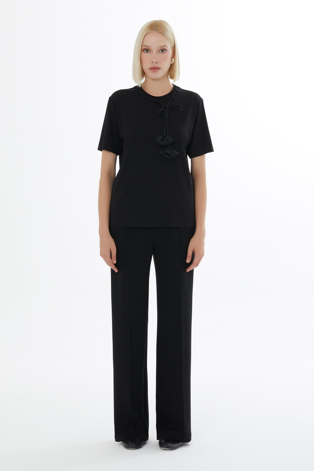 Black Blouse with Minimalist Accessory Details