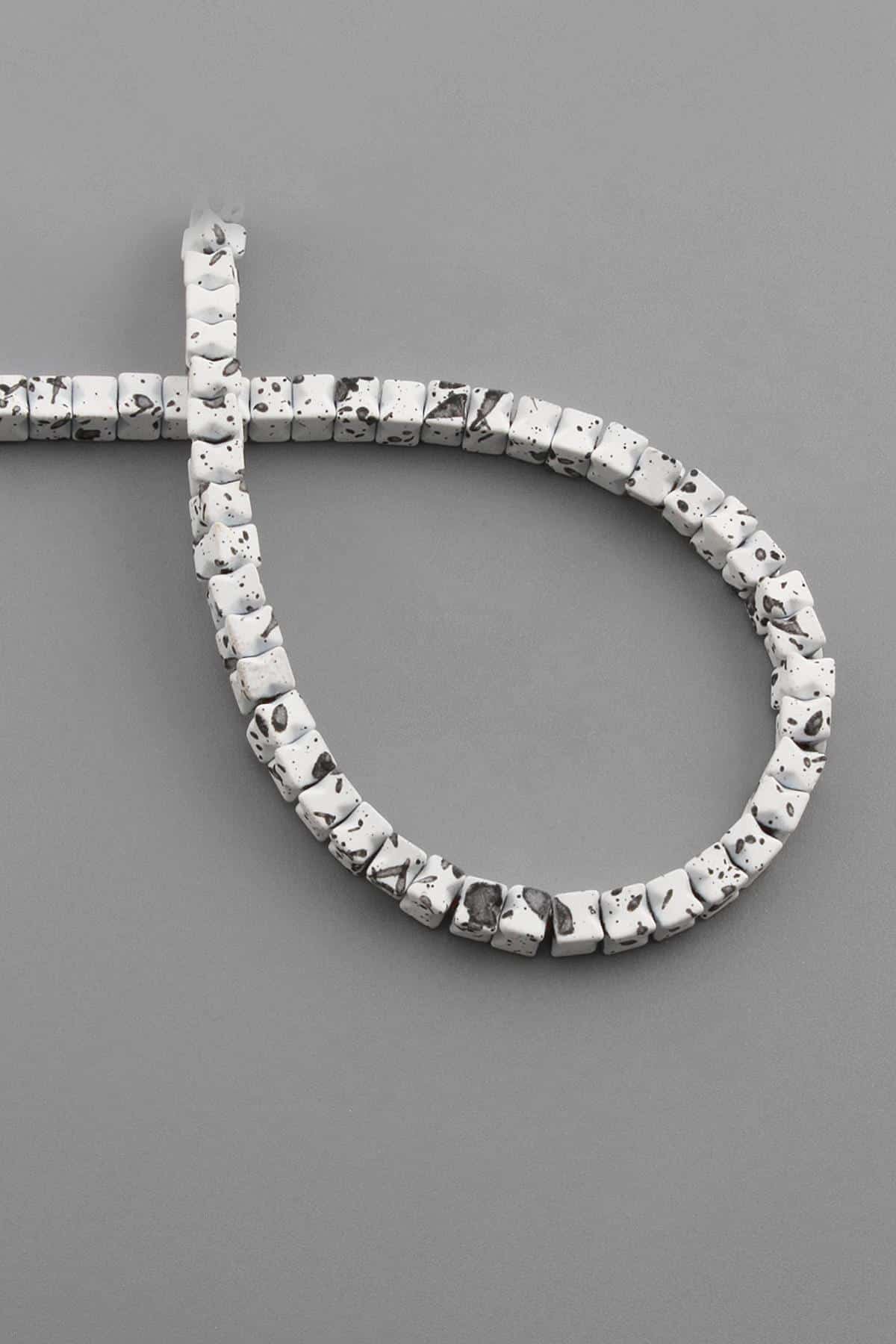 Hematite Natural Stone Matte Mottled White Cube Cut 4x4mm String Of Beads