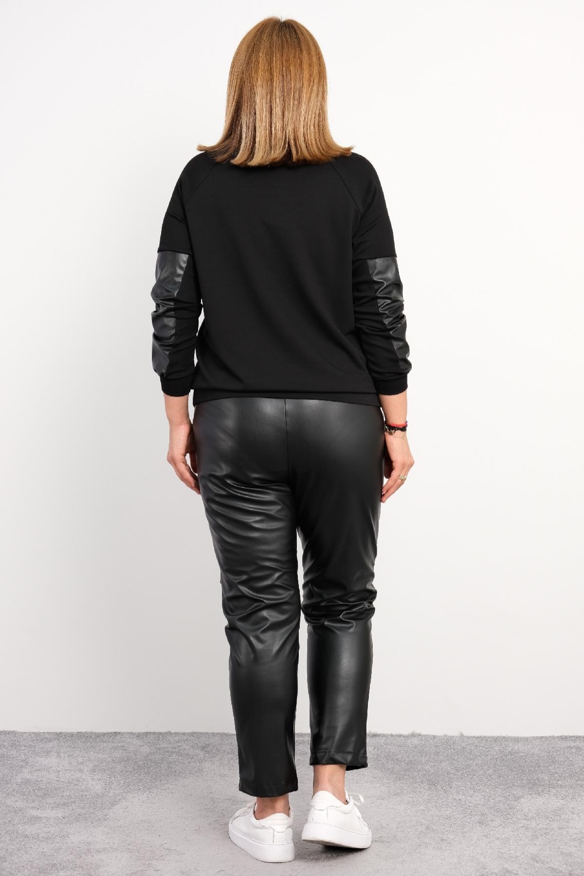 Bu büyük beden kadın ikili takım, modern ve şık tasarımıyla dikkat çekiyor. Takımın üst kısmı uzun kollu ve ön tarafında 