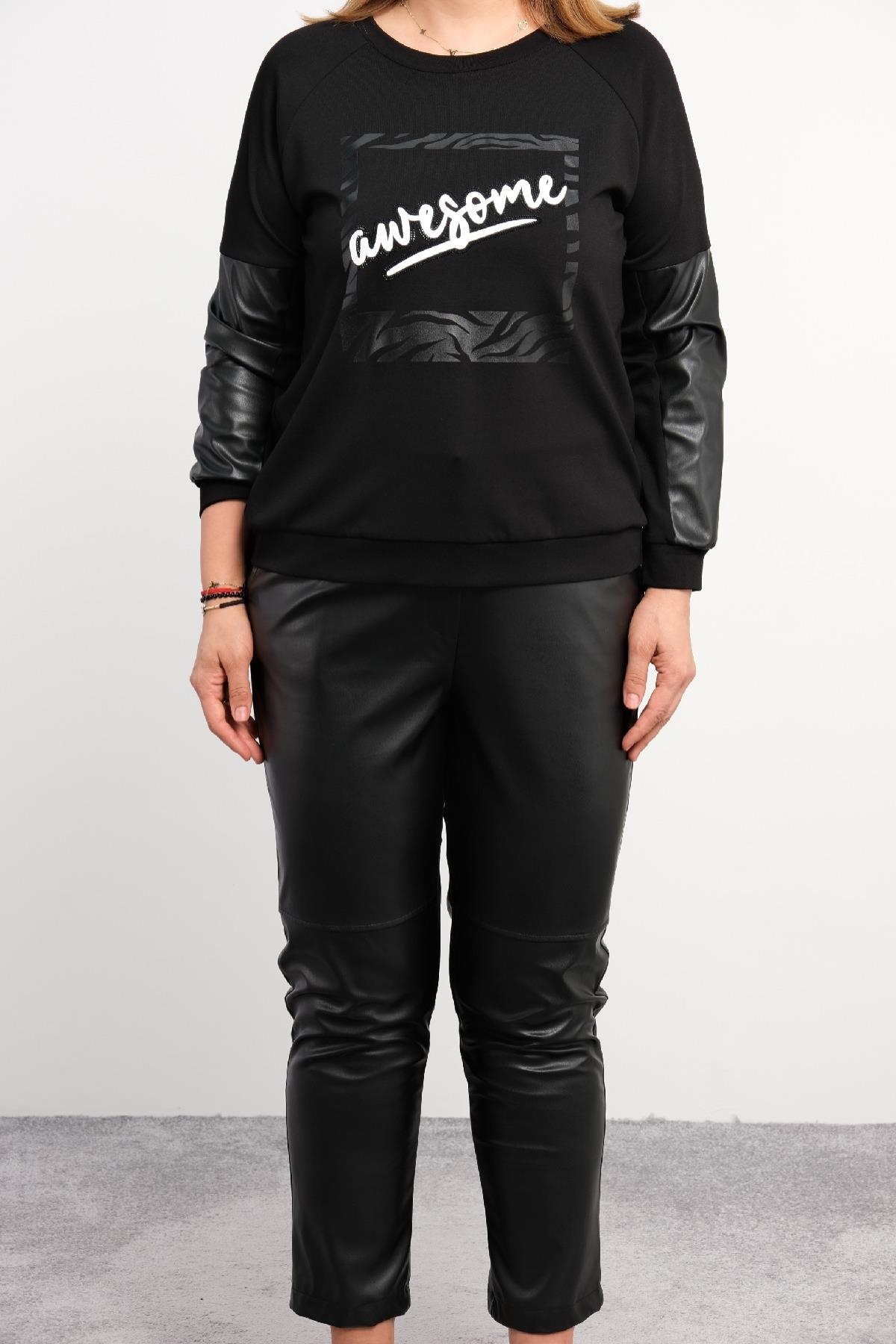 Bu büyük beden kadın ikili takım, modern ve şık tasarımıyla dikkat çekiyor. Takımın üst kısmı uzun kollu ve ön tarafında 