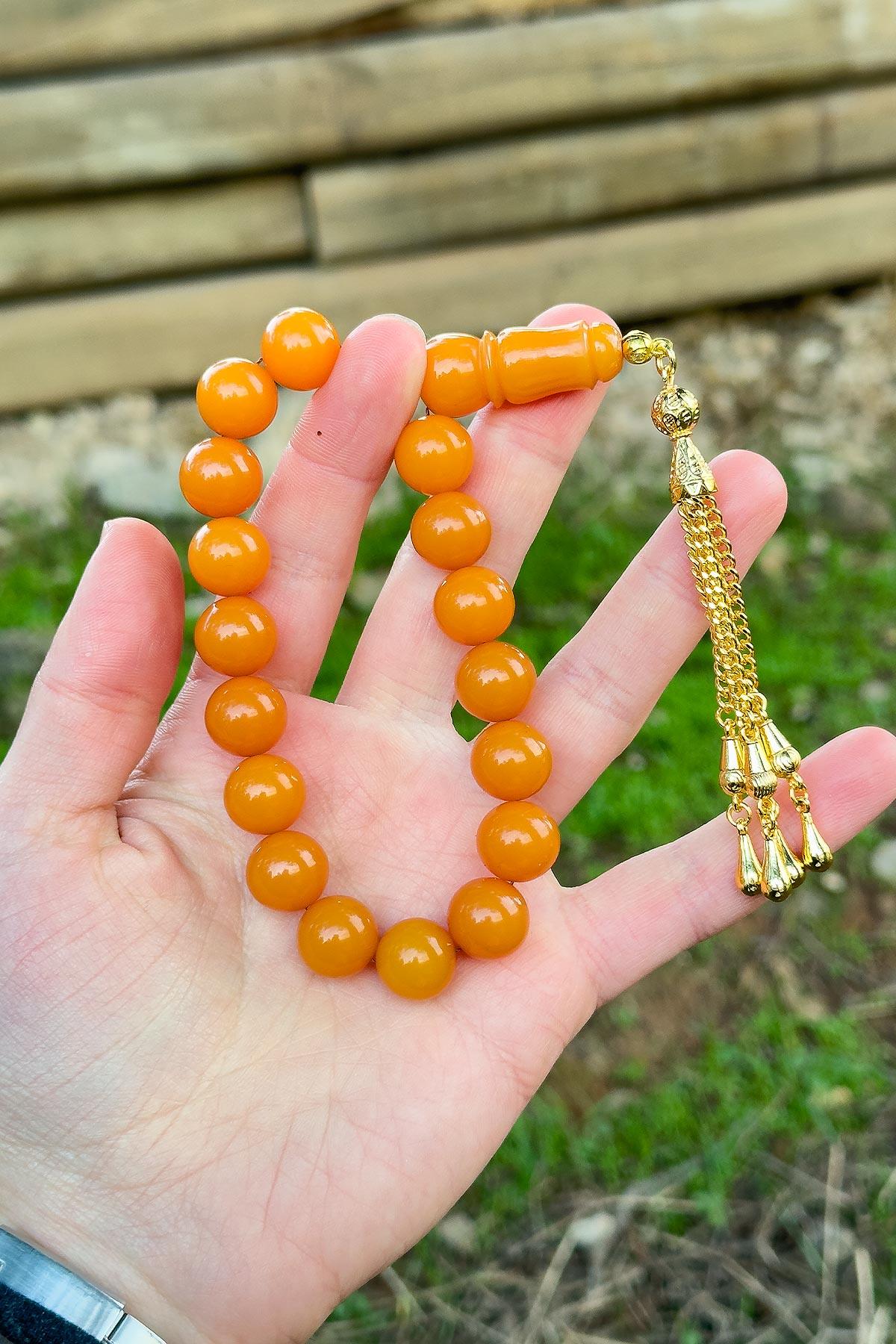 Küre Tane Turuncu Gold Püsküllü 17'lik Sıkma Kehribar Tesbih