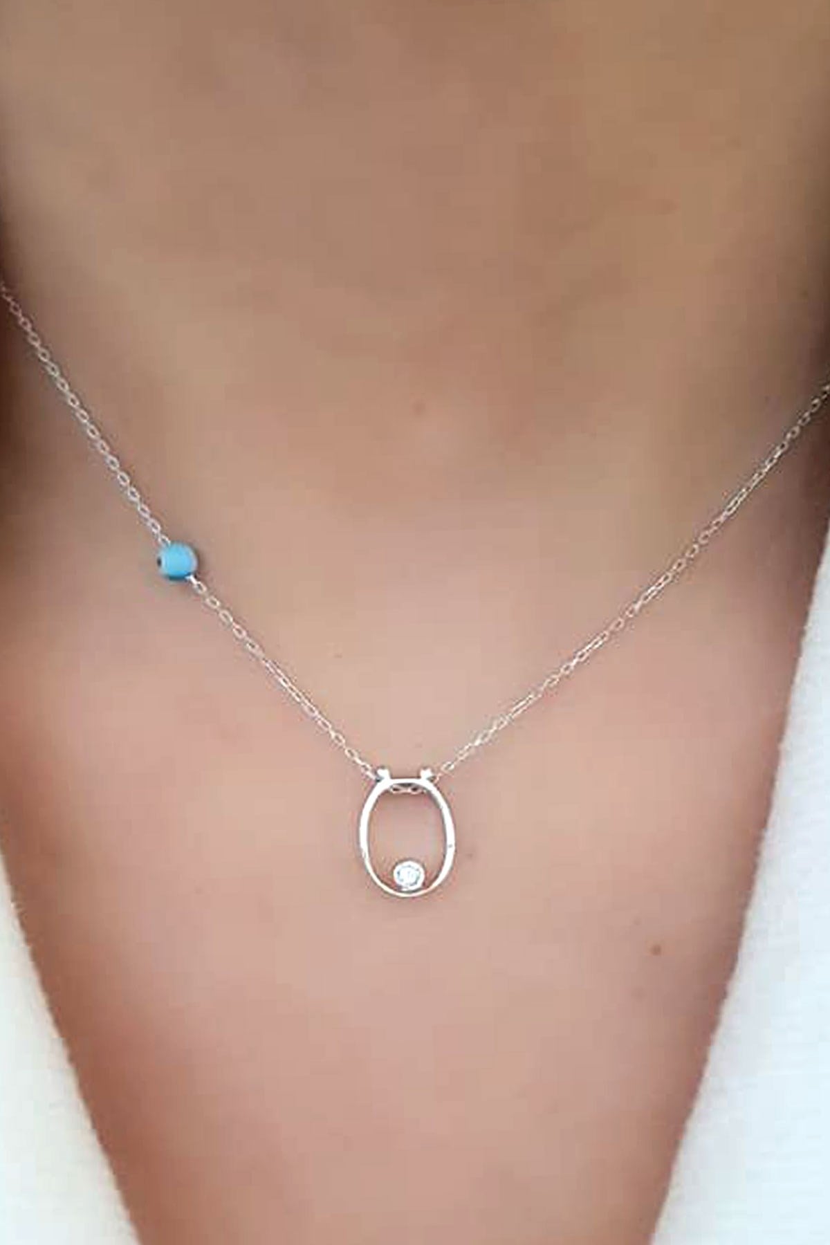 Nazar boncuklu ve zirkon taş detaylı gümüş ö harfi kolye
