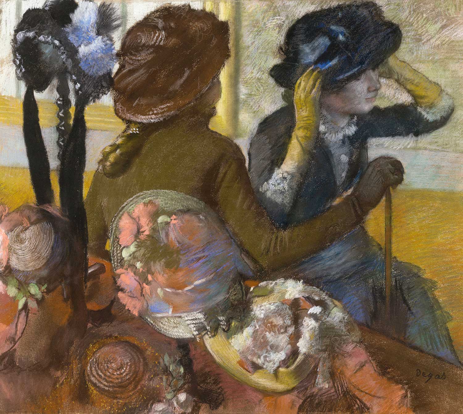 At the Milliner's by Edgar Degas
