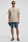 COLLECTIVE Erkek Ön Nakış Arka Baskı Detaylı %100 Organik Pamuk Oversize Kısa Kol Taş Rengi T-Shirt