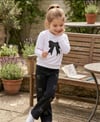 Kız Çocuk TakımKız Çocuk Taşlı Kot Pantolon ve Fiyonklu Sweatshirt İkili Takım Siyah