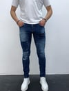 Erkek Mavi Slim Fit Yıpratılmış ve Boya Detaylı Denim Pantolon – Modern Sokak Stili, Rahat Kesim