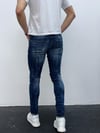 Erkek Mavi Slim Fit Yıpratılmış ve Boya Detaylı Denim Pantolon – Modern Sokak Stili, Rahat Kesim