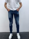 Erkek Mavi Slim Fit Yıpratılmış ve Boya Detaylı Denim Pantolon – Modern Sokak Stili, Rahat Kesim